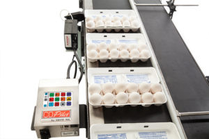 egg cartons on the conveyor of squid ink co-pilot high resolution printer