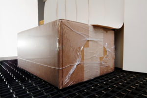 sealed cardboard box exiting Eastey bundling tunnel